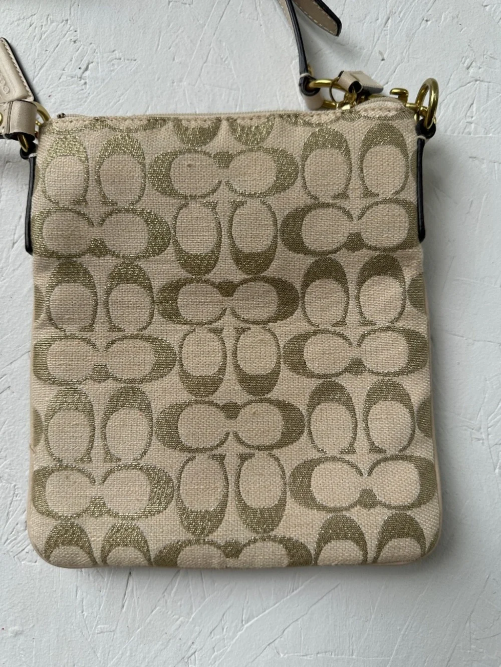 Coach Kristin Signature Crossbody Swing Bag in a metallic gold and beige fabric